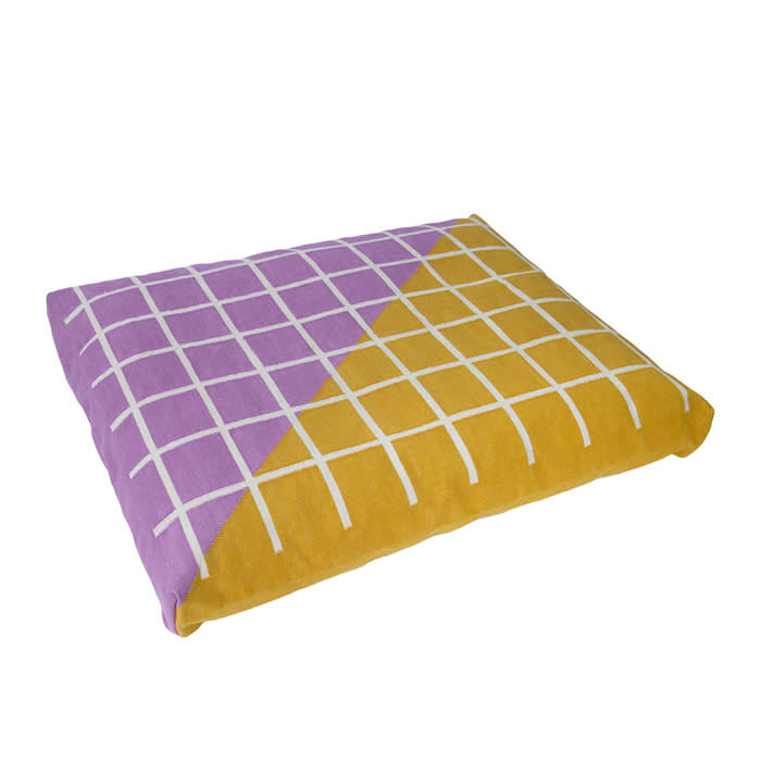 pink and yellow dog bed with white checkers