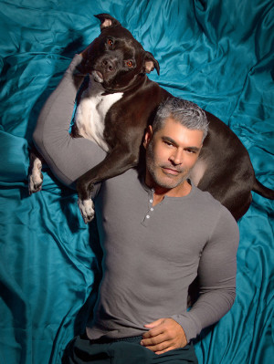 Mike Ruiz and a black pit bull dog.
