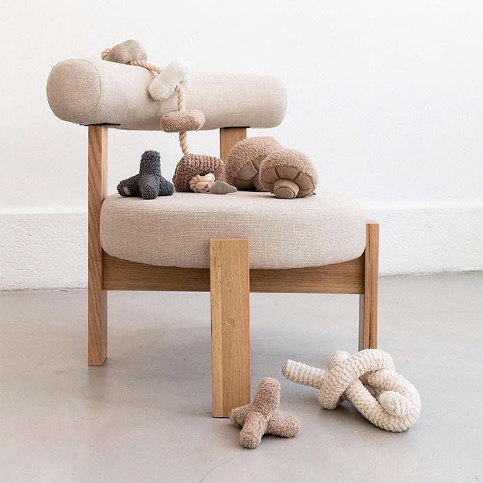 neutral chair with plush toys scattered around it
