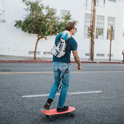 Zach Skow carries his dog Cora in his backpack 