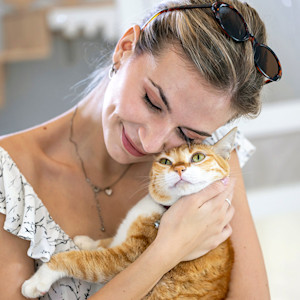 Woman holding cat in her arms.