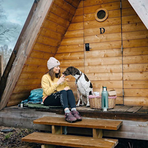 Woman with her dog at an Eastwind Hotel.
