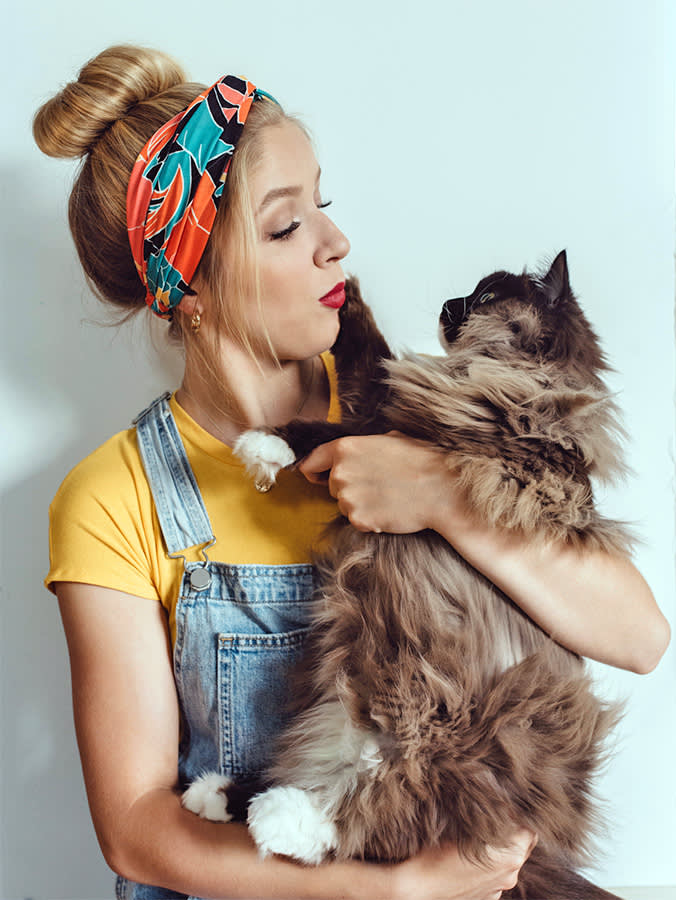 Woman holding cat in her arms.