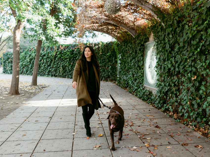 Woman walking her dog in a park