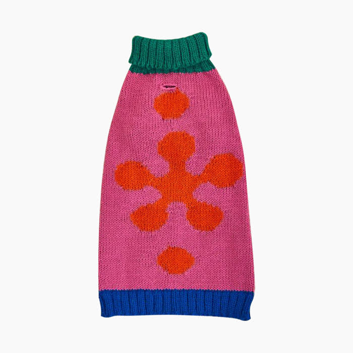 pink red green and blue sweater with snowflake shape on back