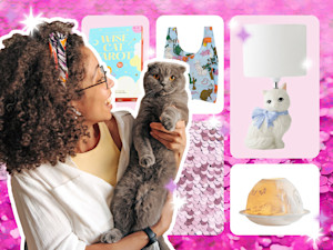 Woman holding up her gray cat.