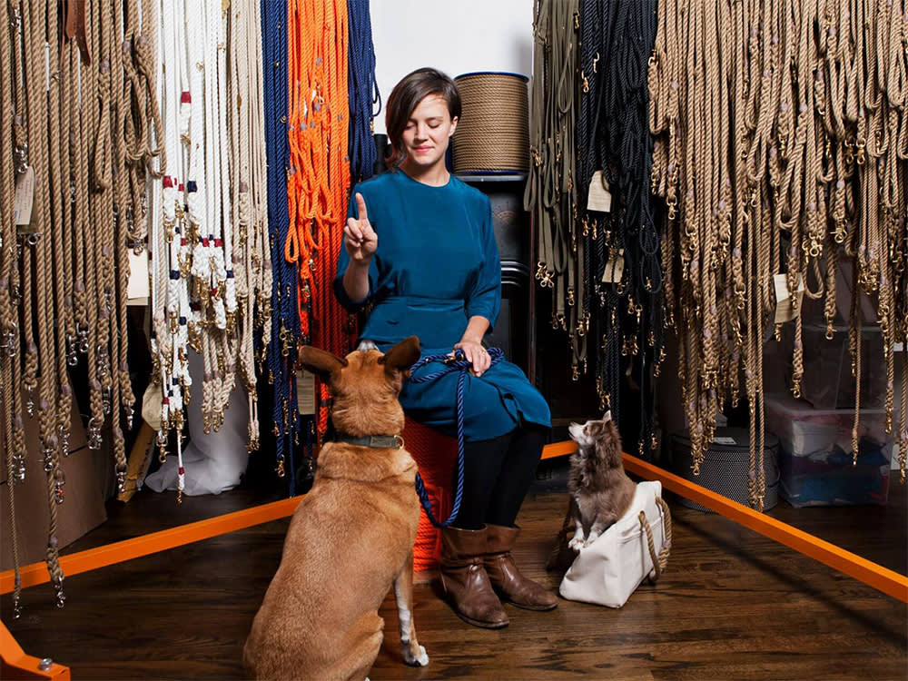 bethany obrecht asks dogs to sit, surrounded by leashes