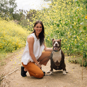 Asha Leo walks with her psychiatric service dog, Pirate, on a trail