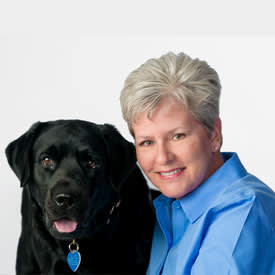 Veterinarian Dr. Wendy Hauser poses with her Labrador