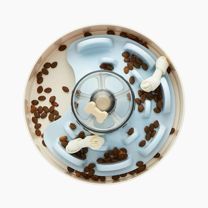 interactive feeder in blue and white with kibble