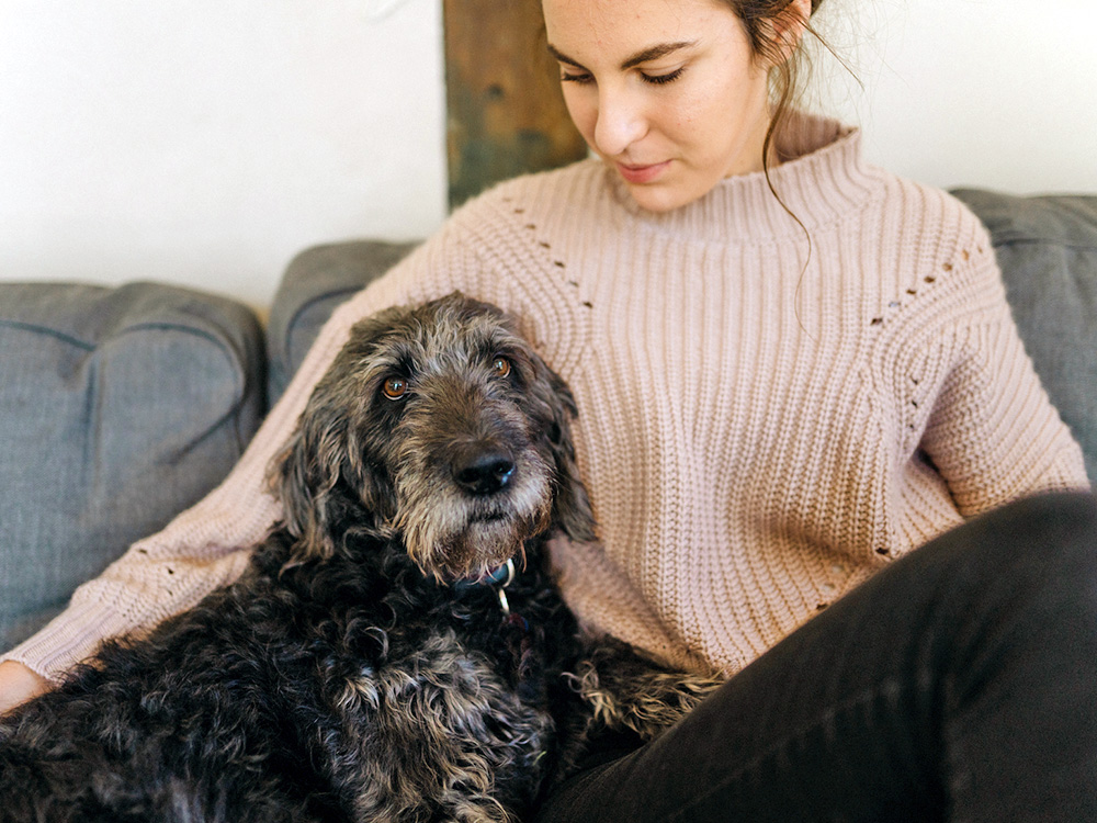 Dog and woman on sofa