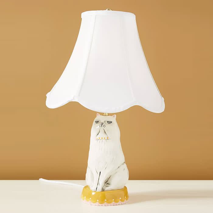 white lampshade on top of a white cat shaped lamp 
