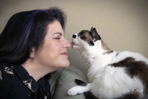 Marci Koski greets a black-and-white cat.
