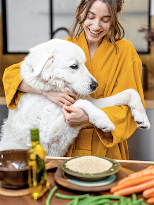 Woman baking her dog some homemade treats.