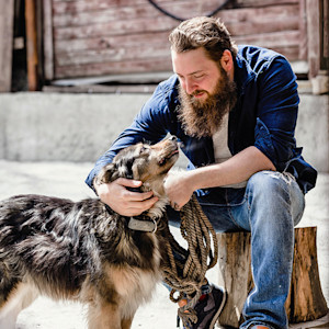 Man looking into his dog's eyes.