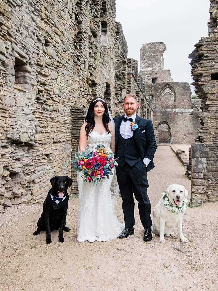Bride and groom on their wedding day with their two dogs