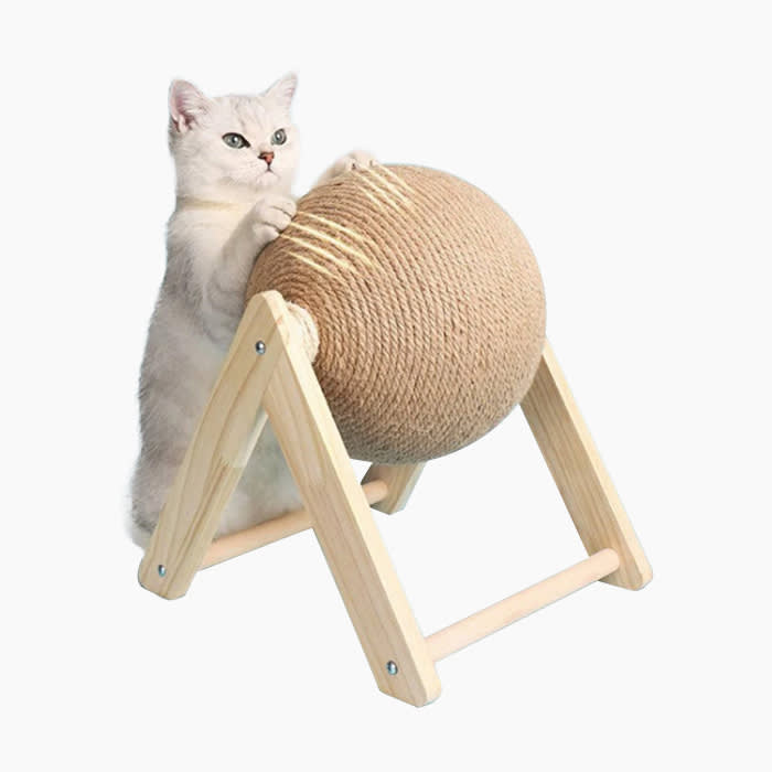 the sisal cat scratcher ball being used by a white cat