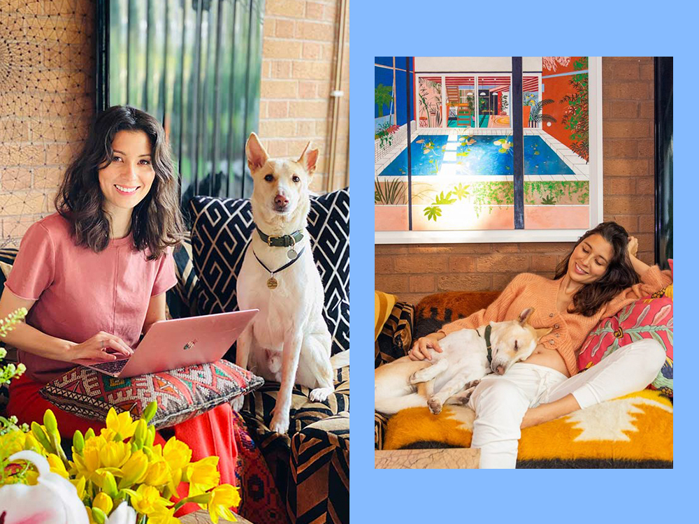 Jasmine Hemsely sitting with computer next to dog