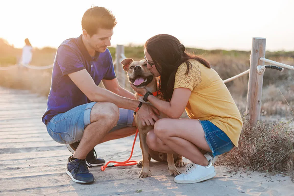 Two people with dog outside