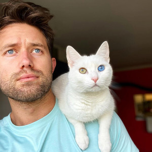 nathan the cat lady in blue shirt with cat with one blue eye