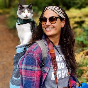 Janelle Leeson on a hike with her cat in a backpack.