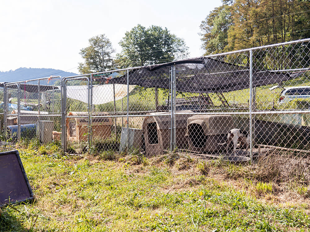 a row of small crates behind a chain link fence