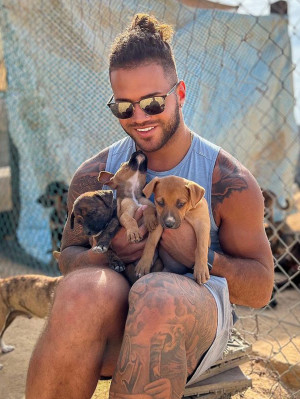 Brady Oliver with three puppies in Mexico.