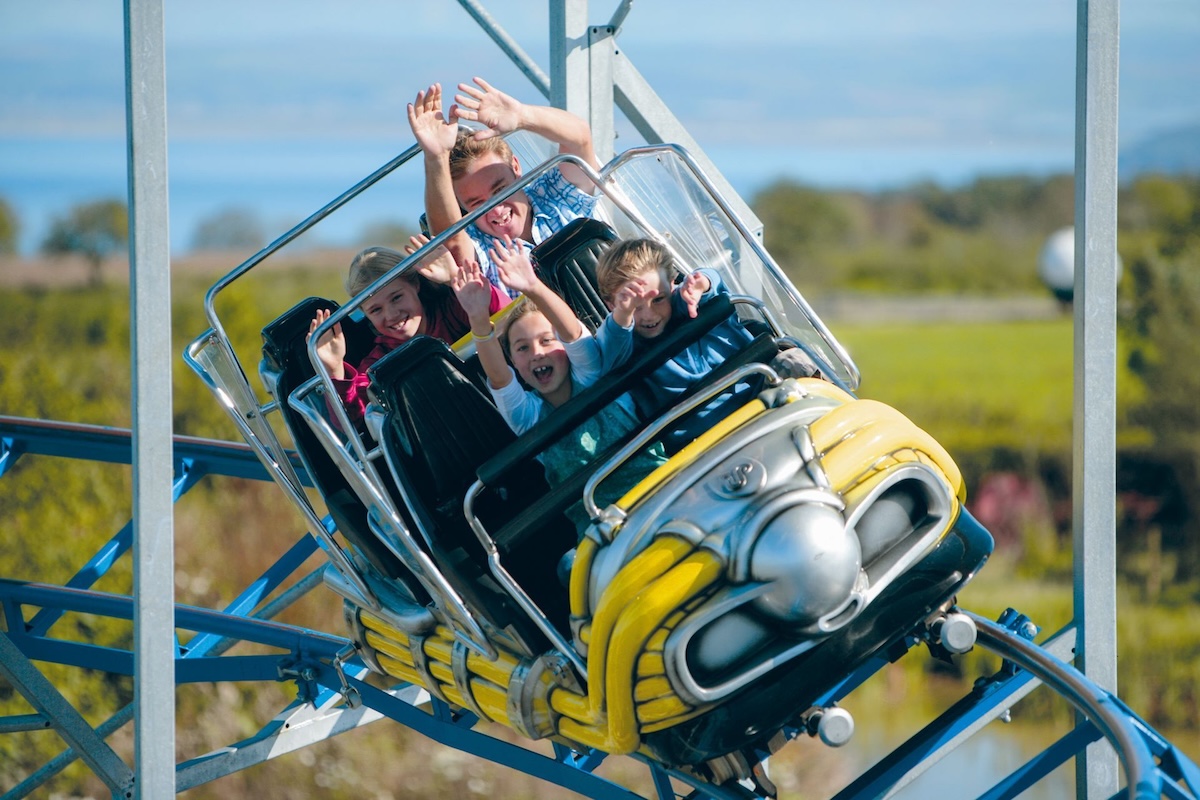 a picture of a car on a small rollercoaster with children inside
