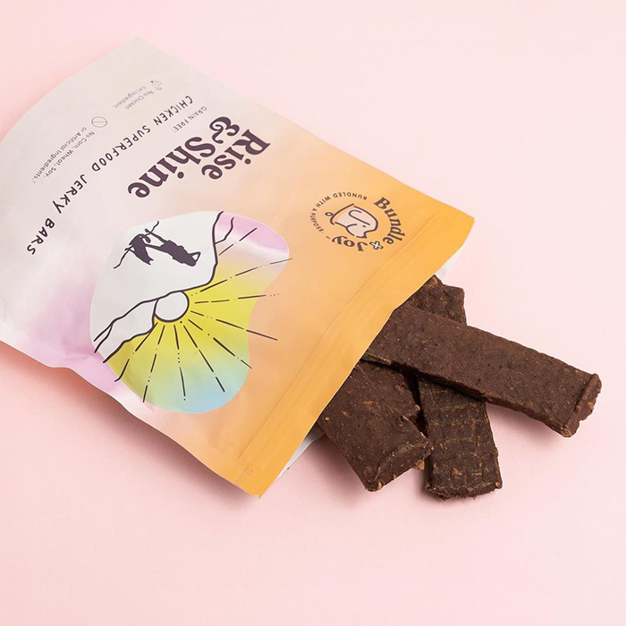 dog jerky treats in pink and orange bag