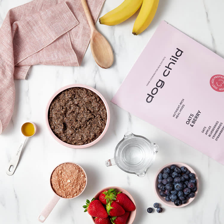 A photo of measured ingredients on a kitchen counter including; blueberries, bananas, strawberries, oats, etc. 