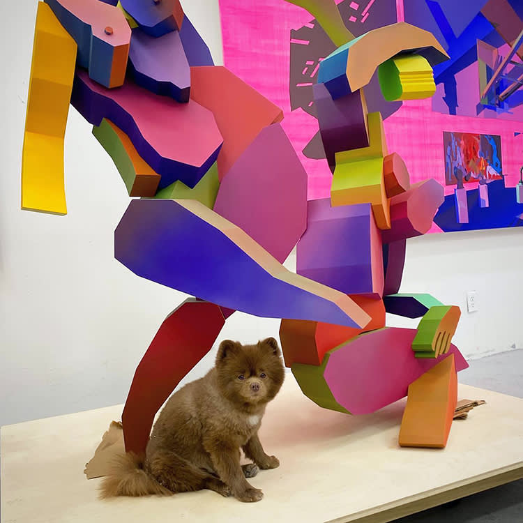 a dog with a sculpture at The Hole
