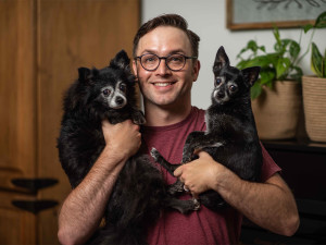 Matt Hobbs holding two small dogs