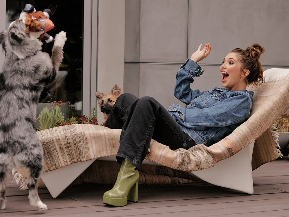Samantha Hanratty outdoors playing with her two dogs
