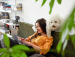 Young Woman Working From Home with Her Dog