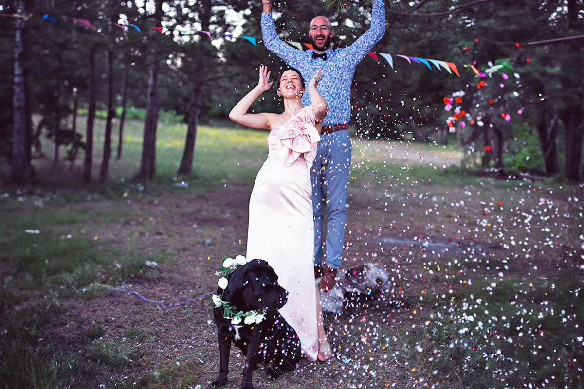 people getting married with a black dog in front of them