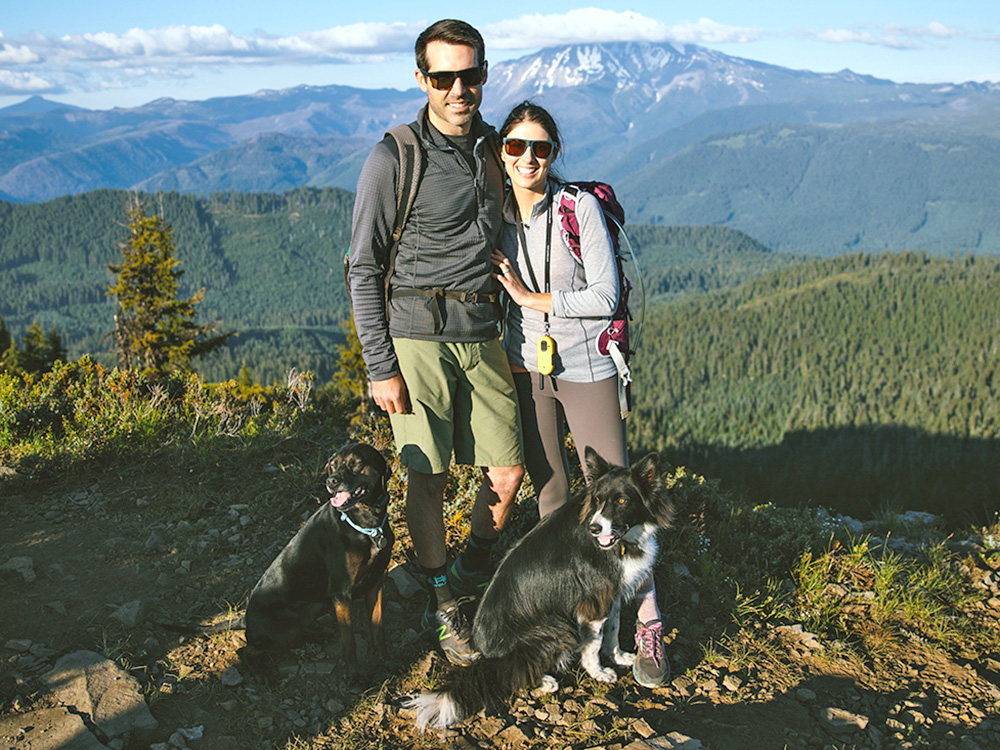 Kacie and Adam Larson with their black dogs, Eddie and Ellie