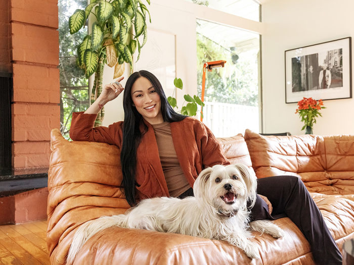 Stephanie Shepherd sitting with her dog on a couch