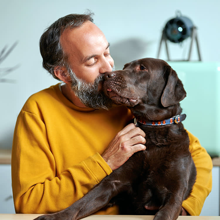 Man with dog at home.