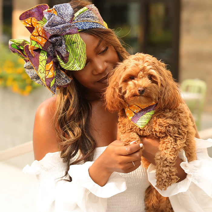dog wearing colorful matching bandana with owner
