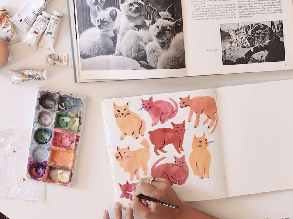 Leah Goren's art supplies and a painting of cats