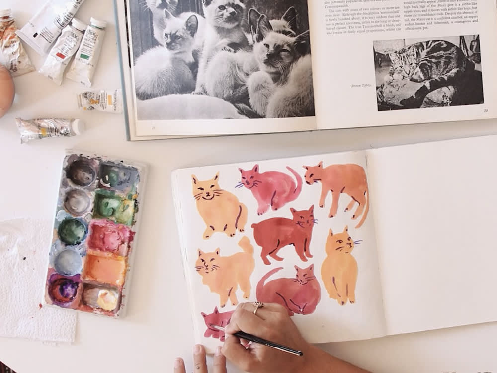 Leah Goren's art supplies and a painting of cats