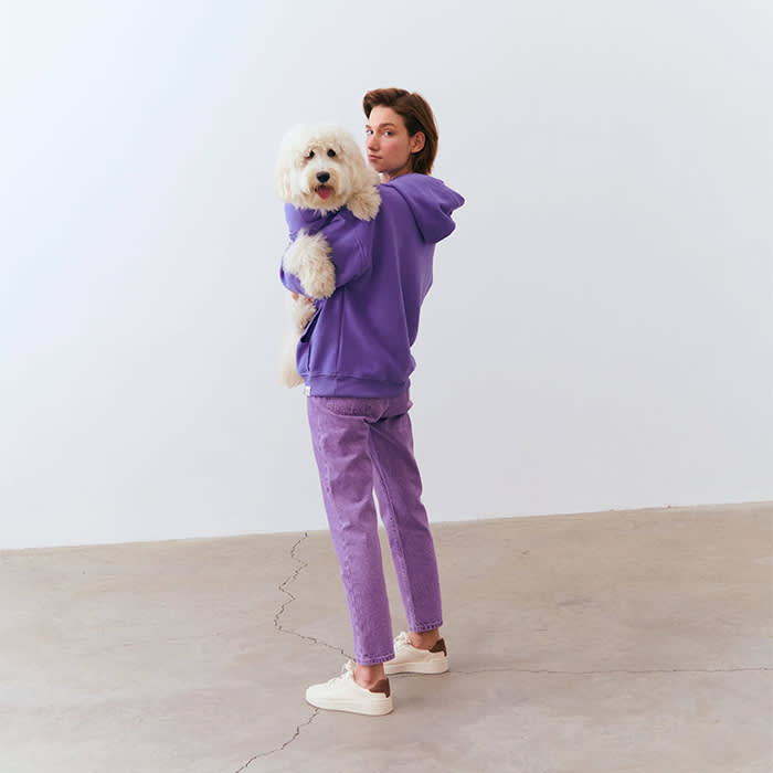 dog and owner in matching purple hoodies