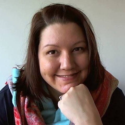 woman with a colorful scarf resting her chin on one hand}}