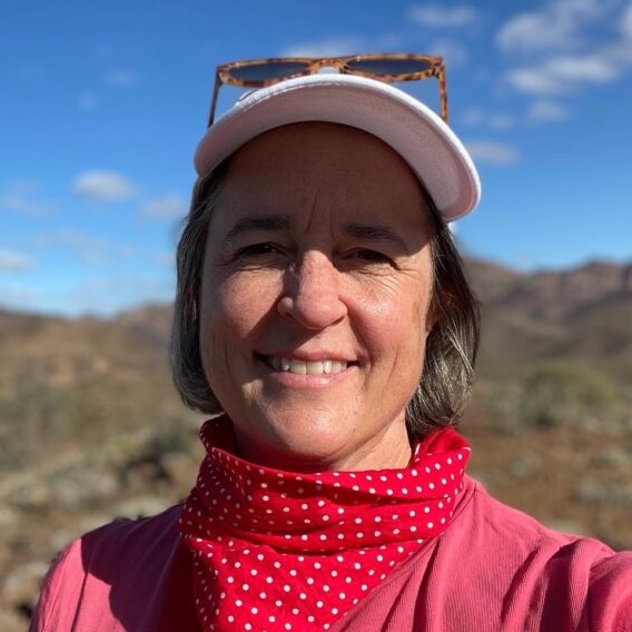 casual headshot of a woman with mountains in the background}}