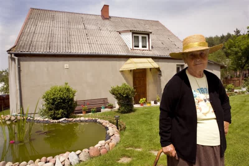 Genowefa Ajtel przed swoim domem, 2008, fot. Janusz Kobyliński, „Mięćmierzanie”