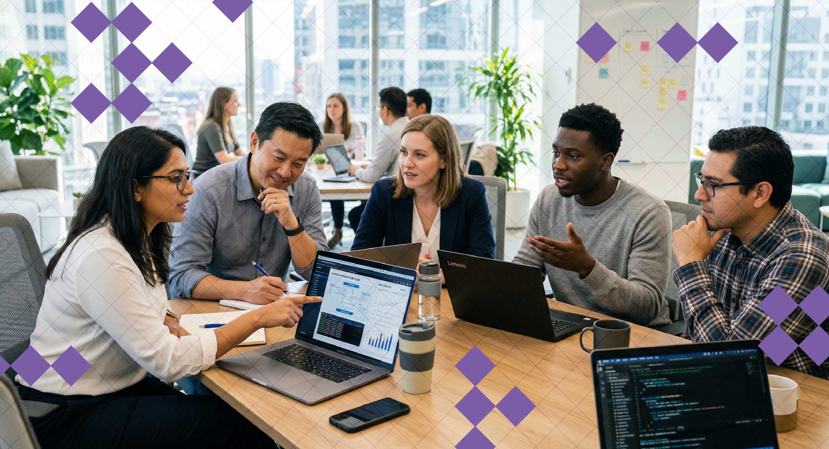 A team sits at a desk discussing analytics displayed on a laptop screen.