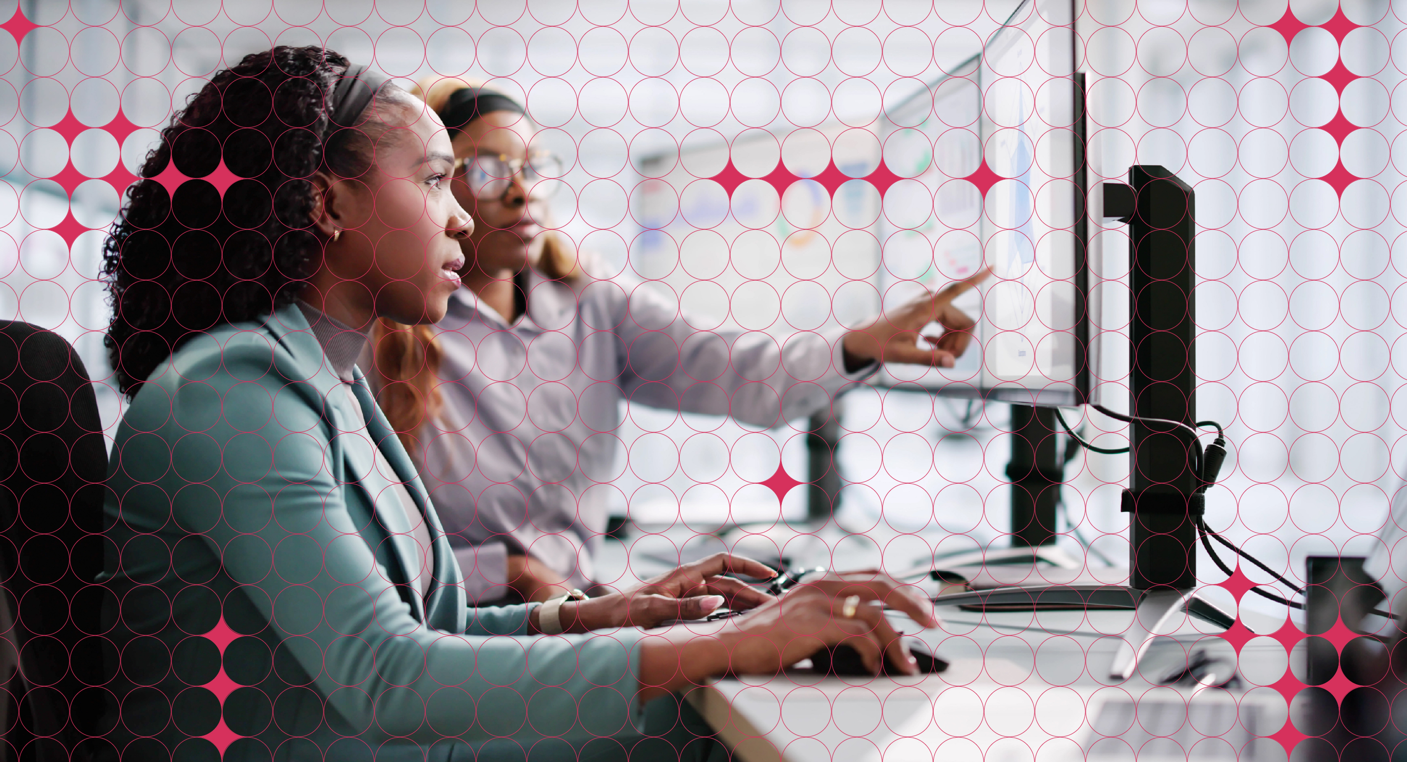 Two colleagues work in front of a computer