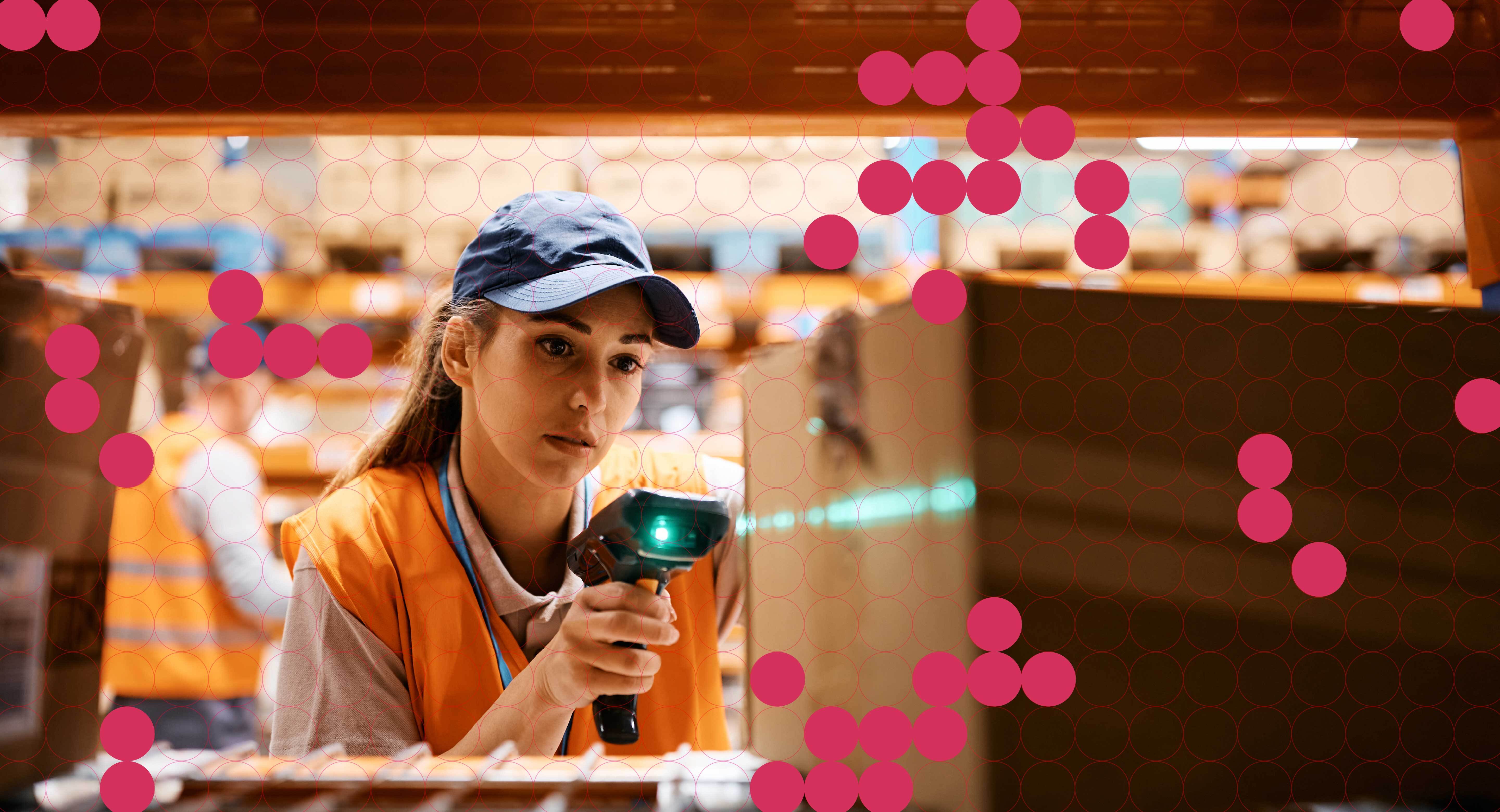 A worker in a warehouse scans a box on a shelf with a handheld device.
