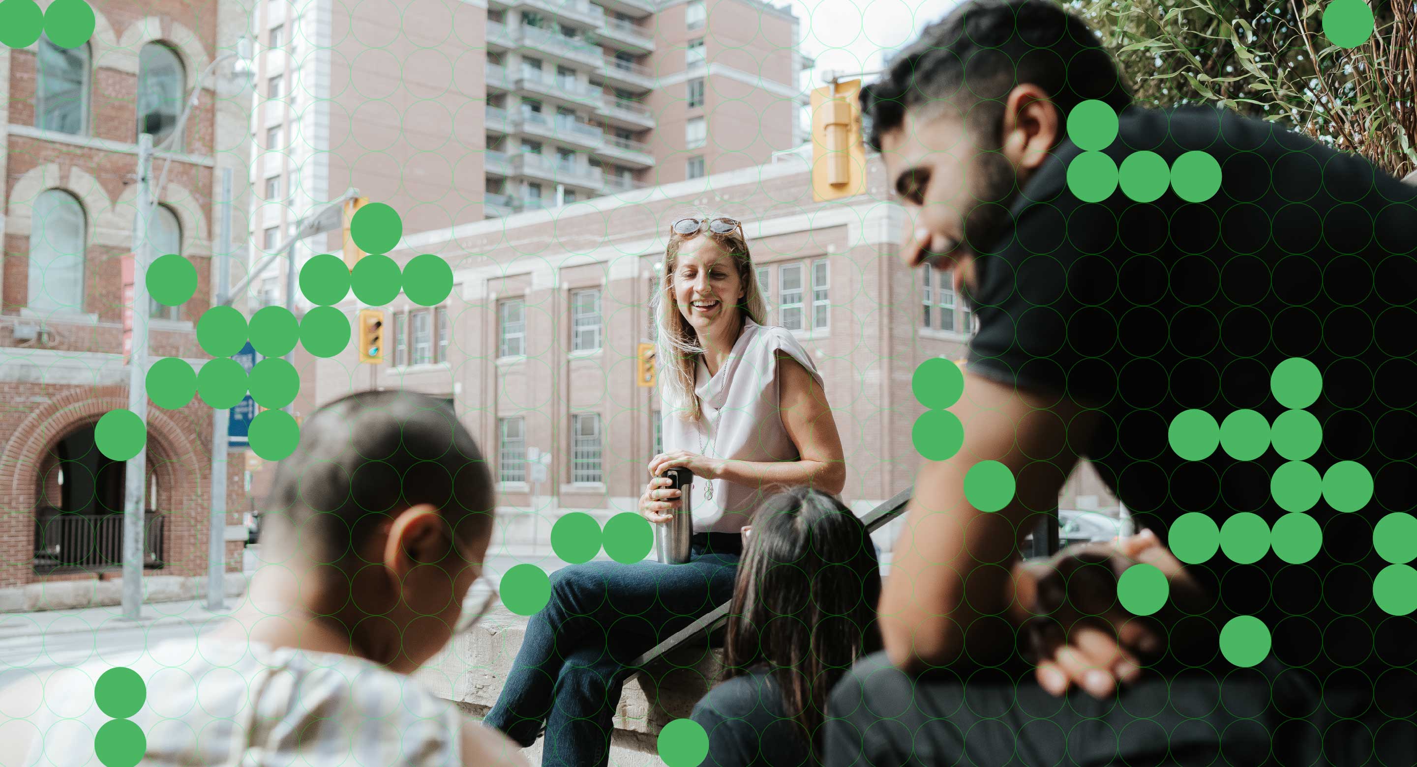 Orium team members sit on the front steps of the former Orium headquarters in Toronto.