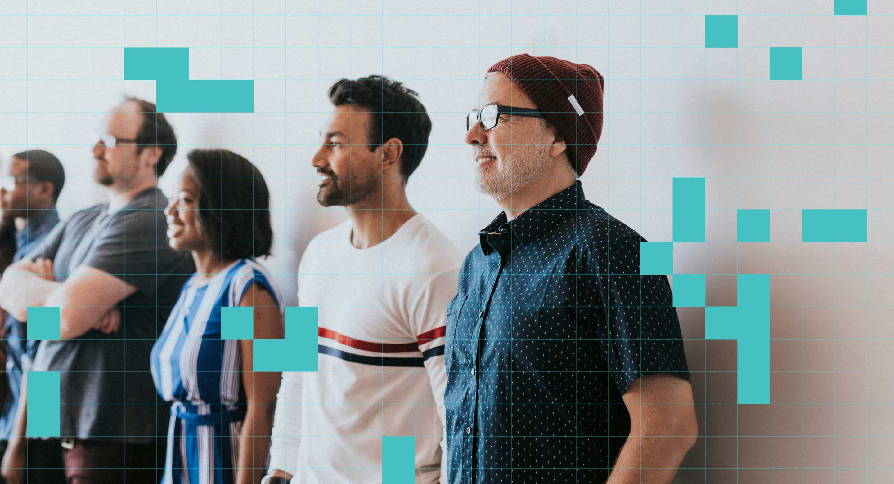A group of coworkers stands together 